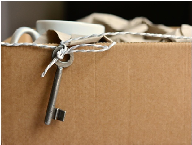 items packed in a cardboard box with a key